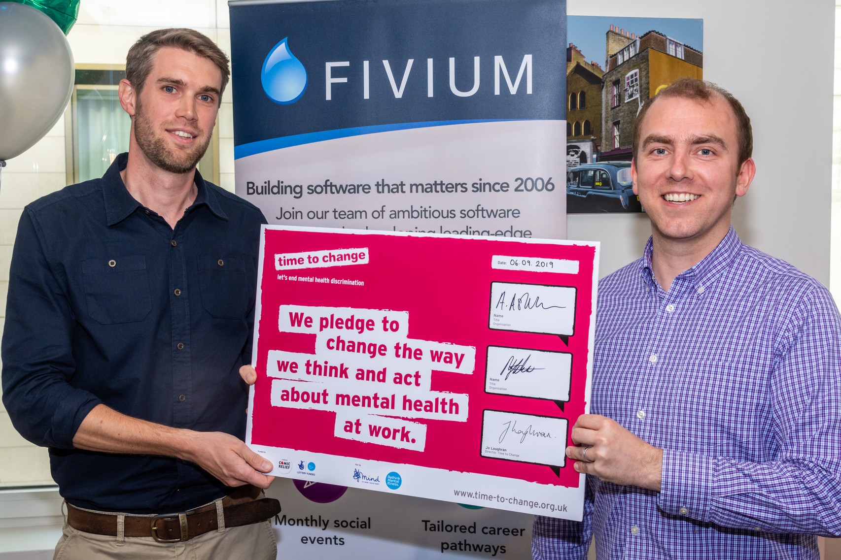 Fivium's directors holding a signed copy of the Time to Change pledge to end mental health discrimination